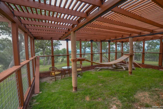 a kitchen with stainless steel appliances granite countertop a sink a microwave refrigerator and chairs