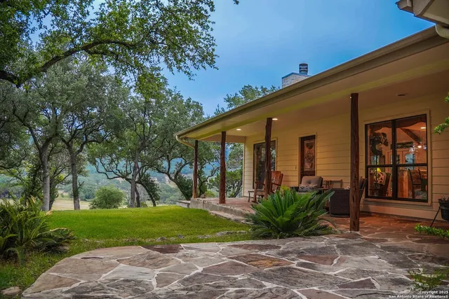 a living room with furniture a fireplace and a large window