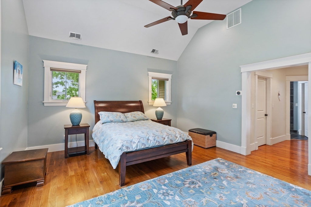 5 Walnut Street Lexington, MA 02421 - Photo 17 of 34 a bedroom with a bed and wooden floor