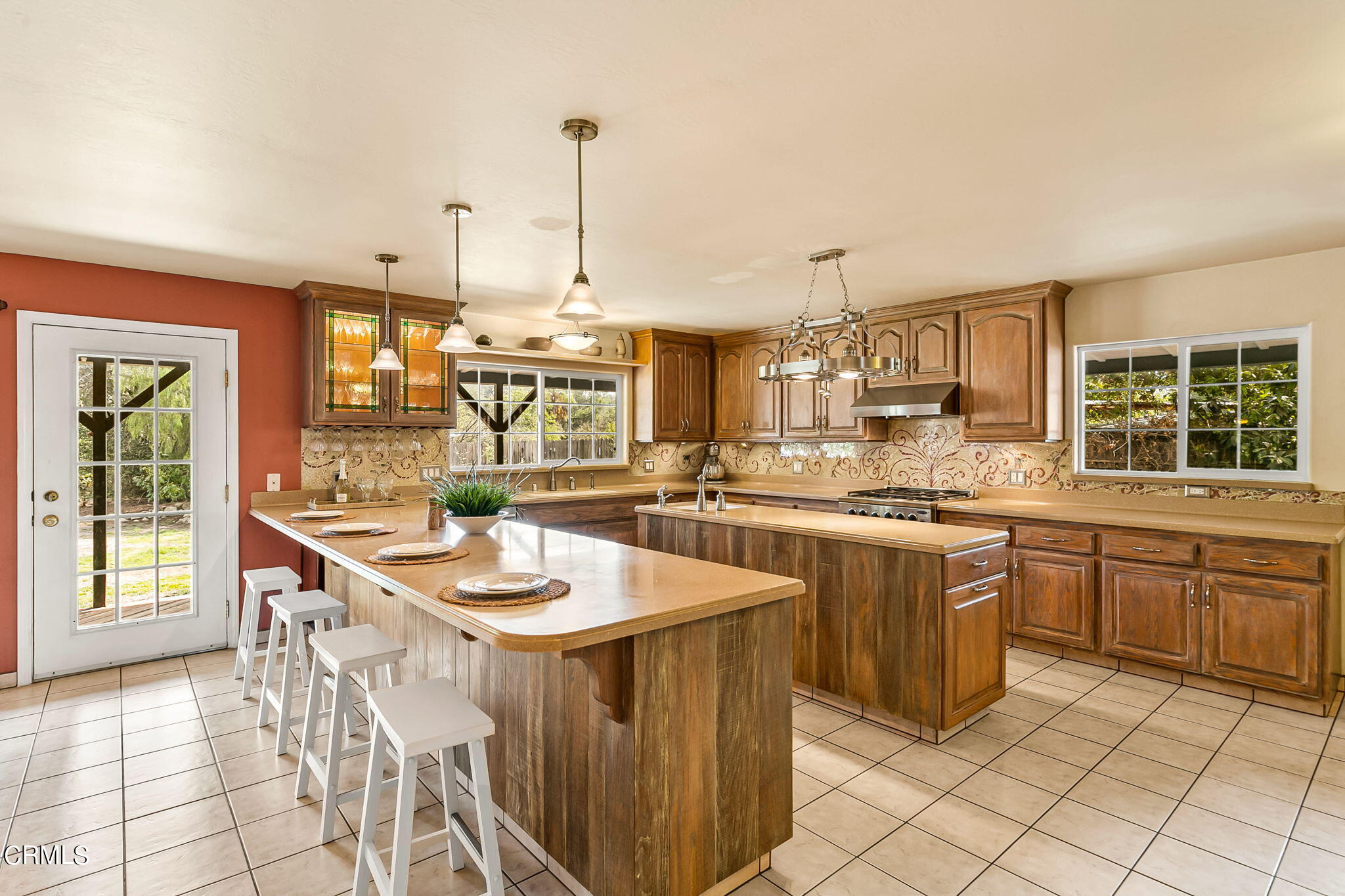 624 South Rice Road Ojai, CA 93023 - Photo 15 of 59 a kitchen with stainless steel appliances kitchen island granite countertop a sink and cabinets