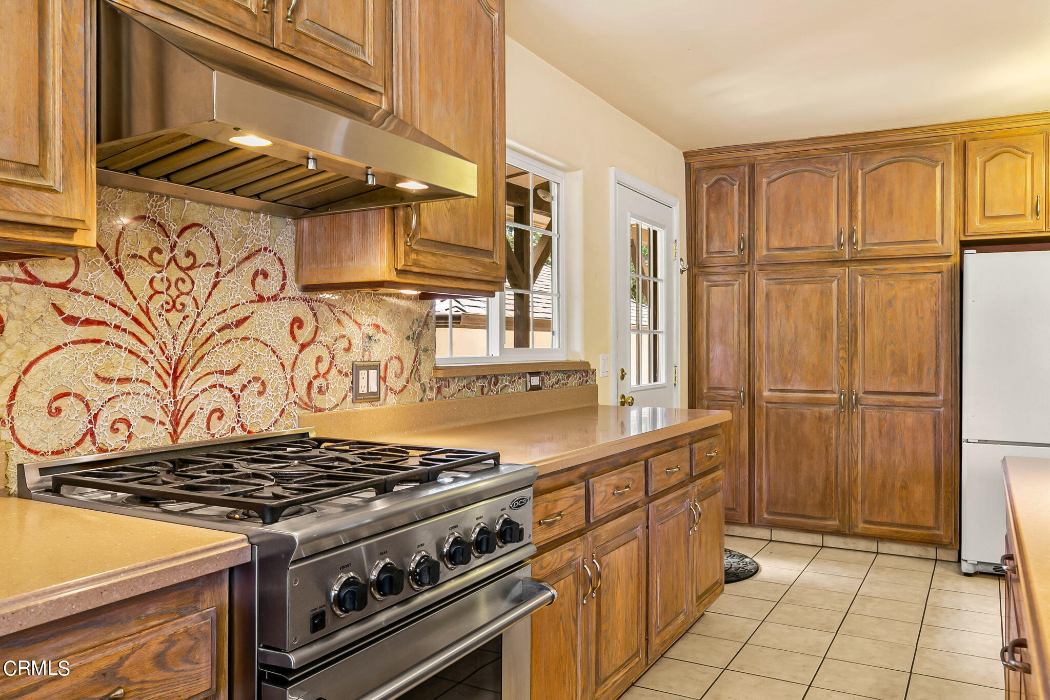 624 South Rice Road Ojai, CA 93023 - Photo 17 of 59 a view of a kitchen with stainless steel appliances granite countertop a stove and a refrigerator