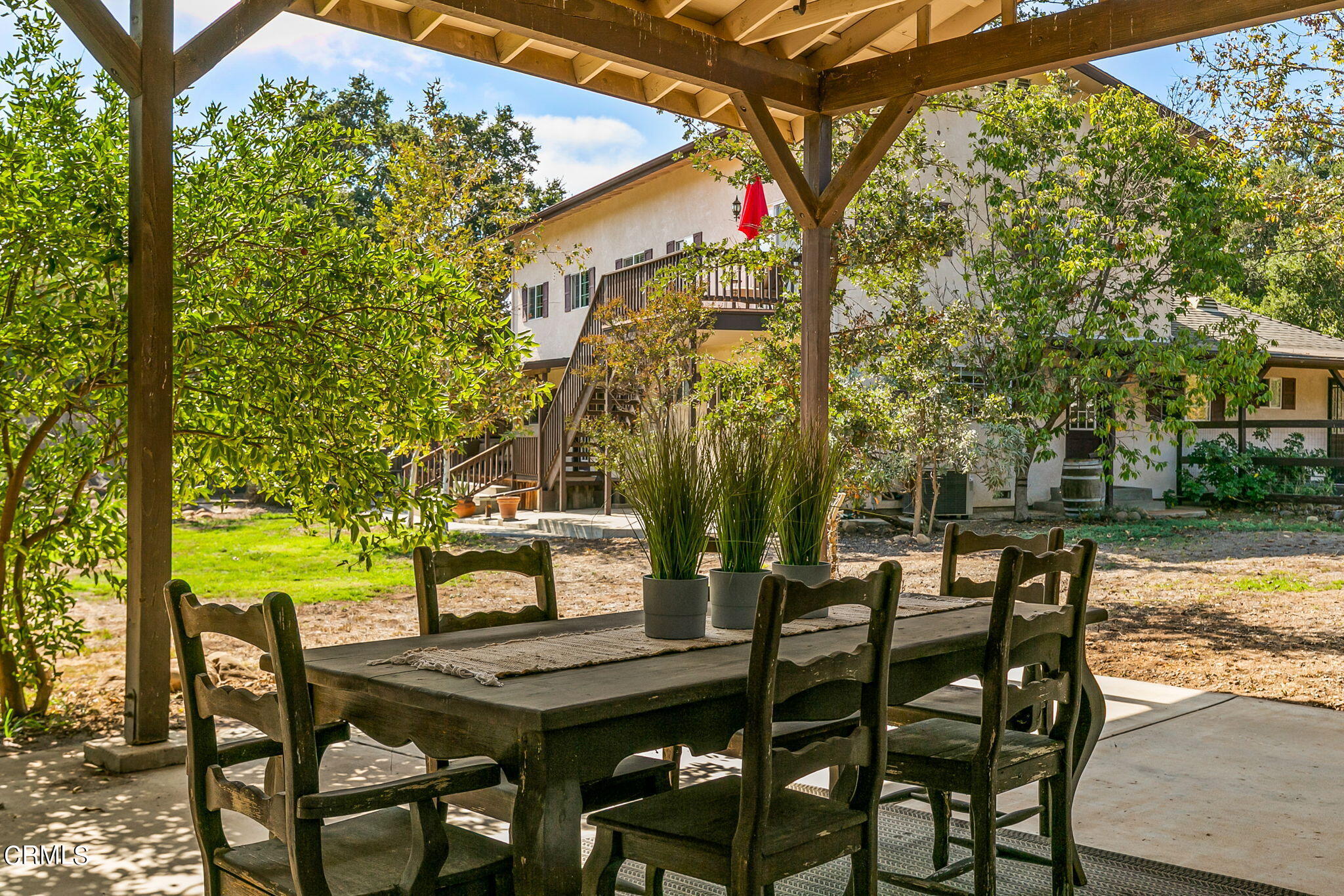 624 South Rice Road Ojai, CA 93023 - Photo 41 of 59 a view of a patio with table and chairs and potted plants