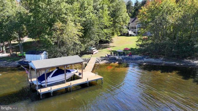 swimming pool with wooden bench and lake view