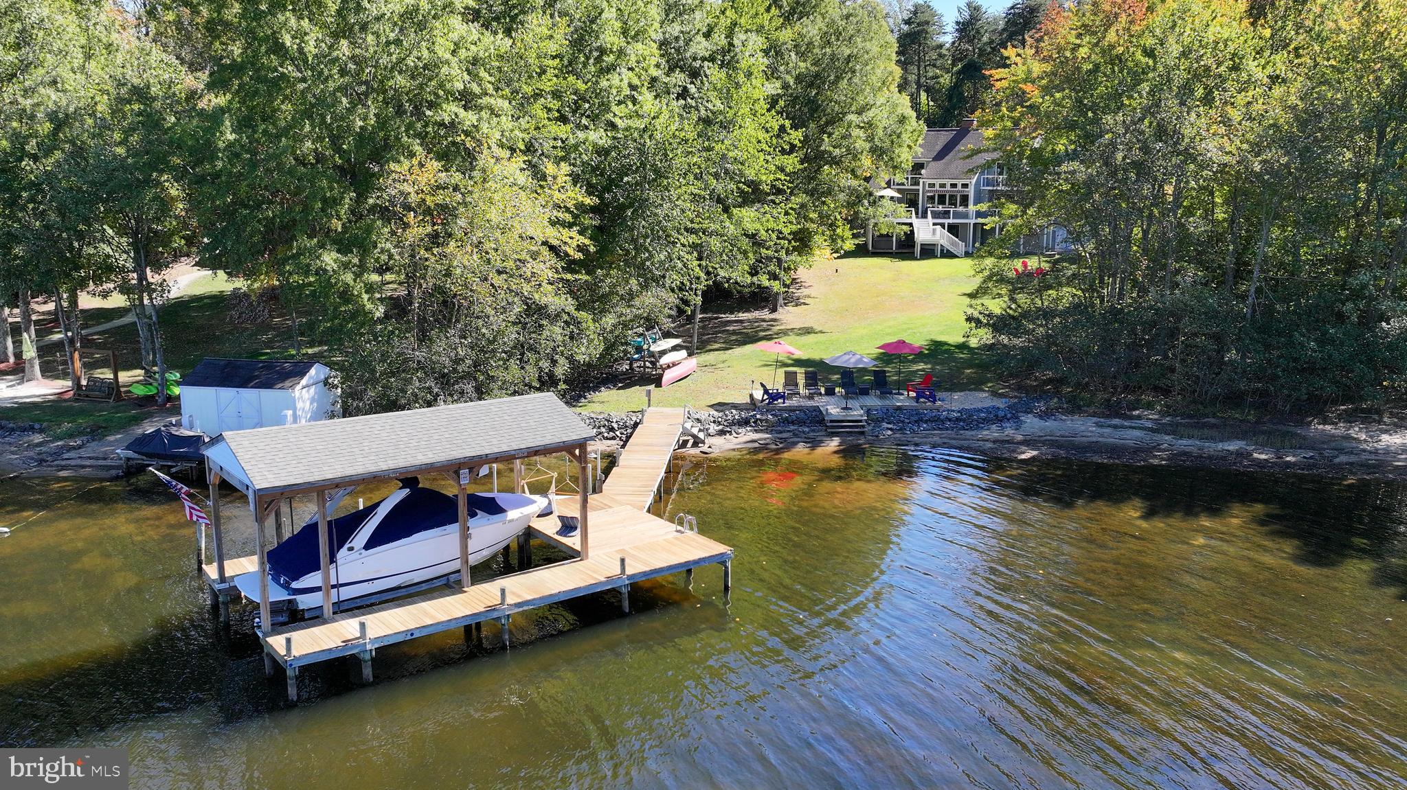 swimming pool with wooden bench and lake view