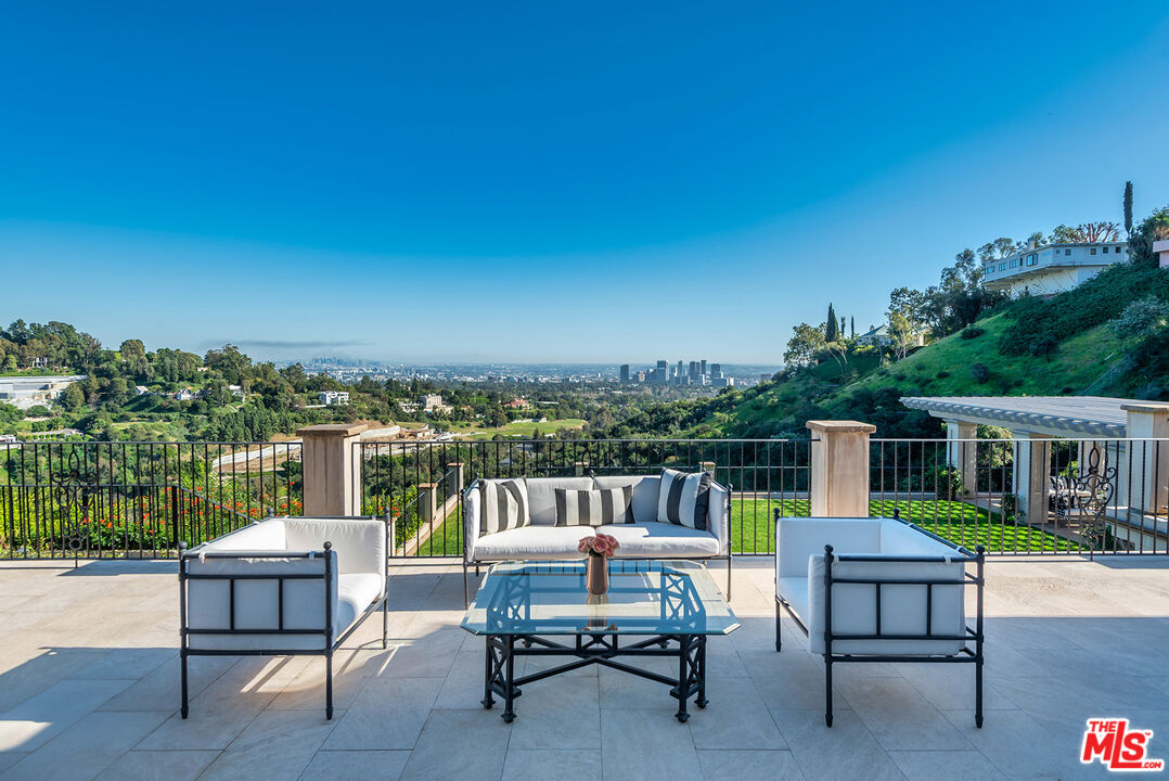 980 Stradella Road Los Angeles, CA 90077 - Photo 25 of 40 a view of a chairs and table in the roof deck