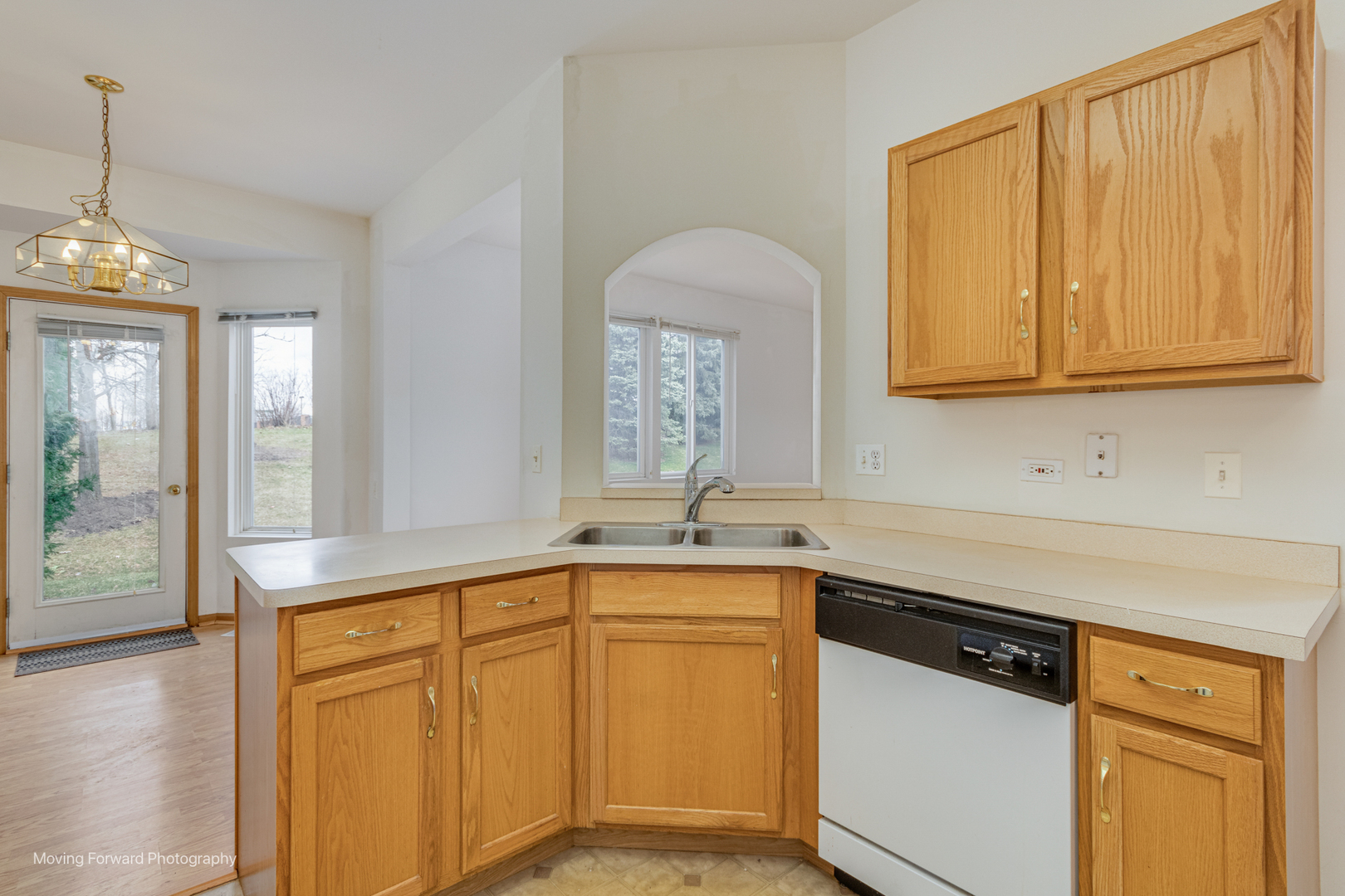 1086 Delta Drive Elgin, IL 60123 - Photo 13 of 29 a kitchen with stainless steel appliances granite countertop a sink and cabinets with wooden floor