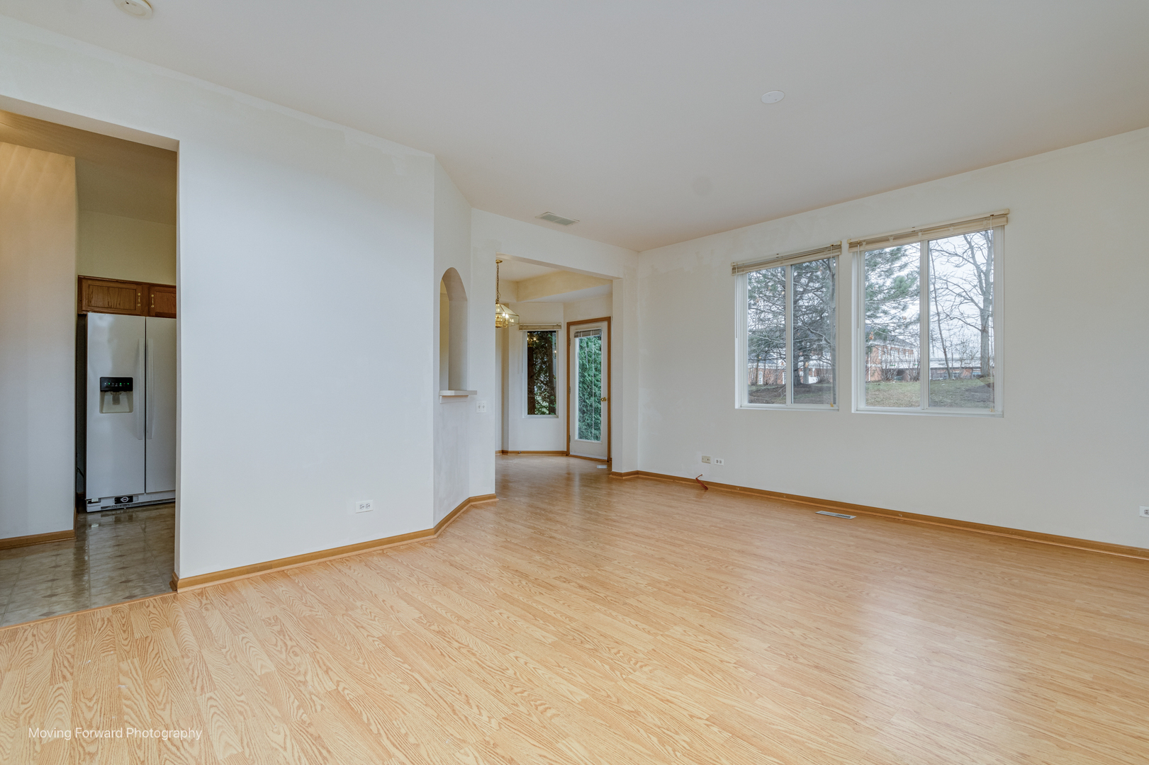 1086 Delta Drive Elgin, IL 60123 - Photo 6 of 29 a view of an empty room with wooden floor and a window