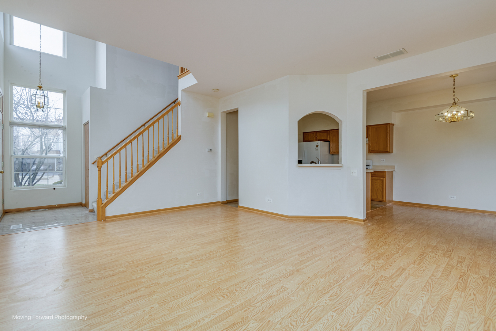 1086 Delta Drive Elgin, IL 60123 - Photo 7 of 29 a view of a big room with wooden floor and windows