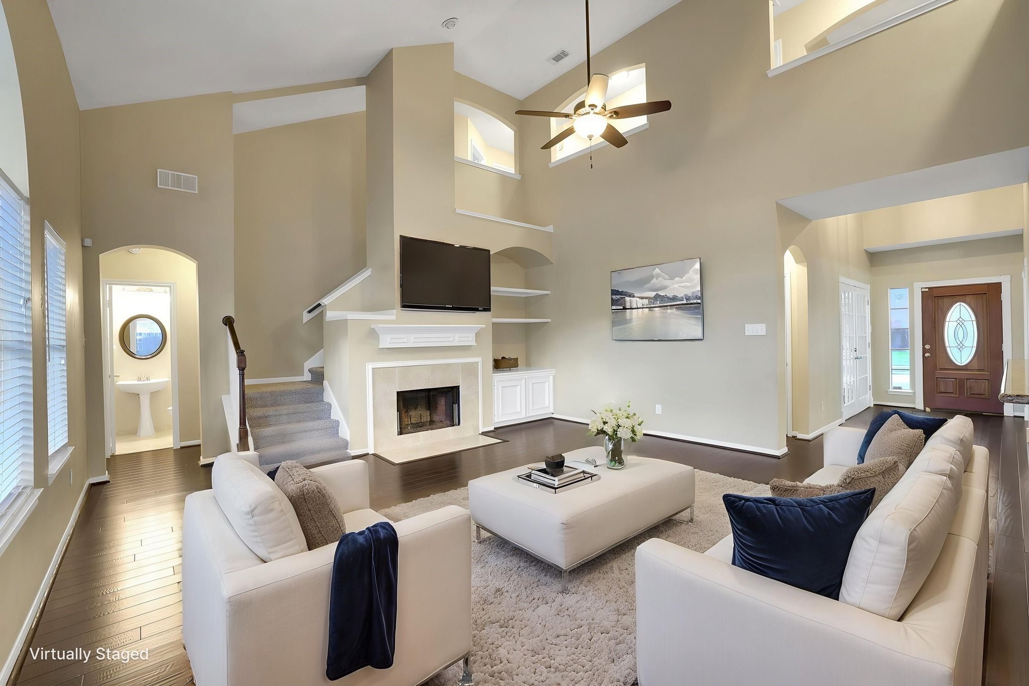 23207 Olive Ridge Court Katy, TX 77494 - Photo 16 of 46 a living room with furniture a fireplace and a chandelier