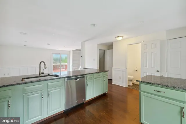 a kitchen with sink and cabinets