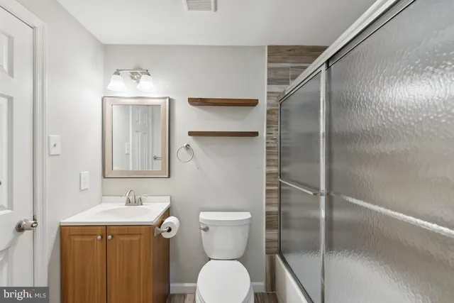 a bathroom with a toilet sink and shower