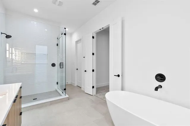 a bathroom with a tub shower and a toilet
