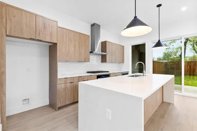 a kitchen with a sink a stove and a refrigerator