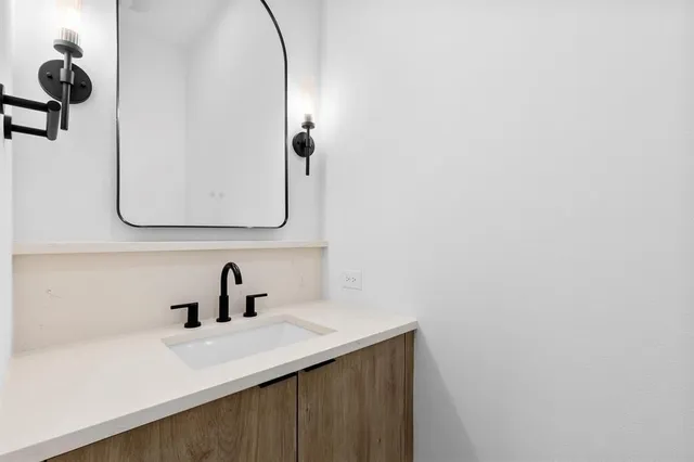 a bathroom with a sink and mirror