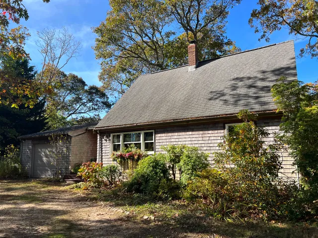 a view of a house with a tree in front