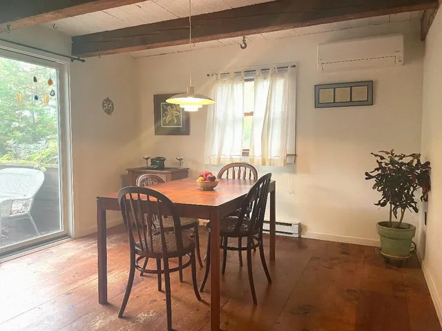 a view of a dining room with furniture and a window