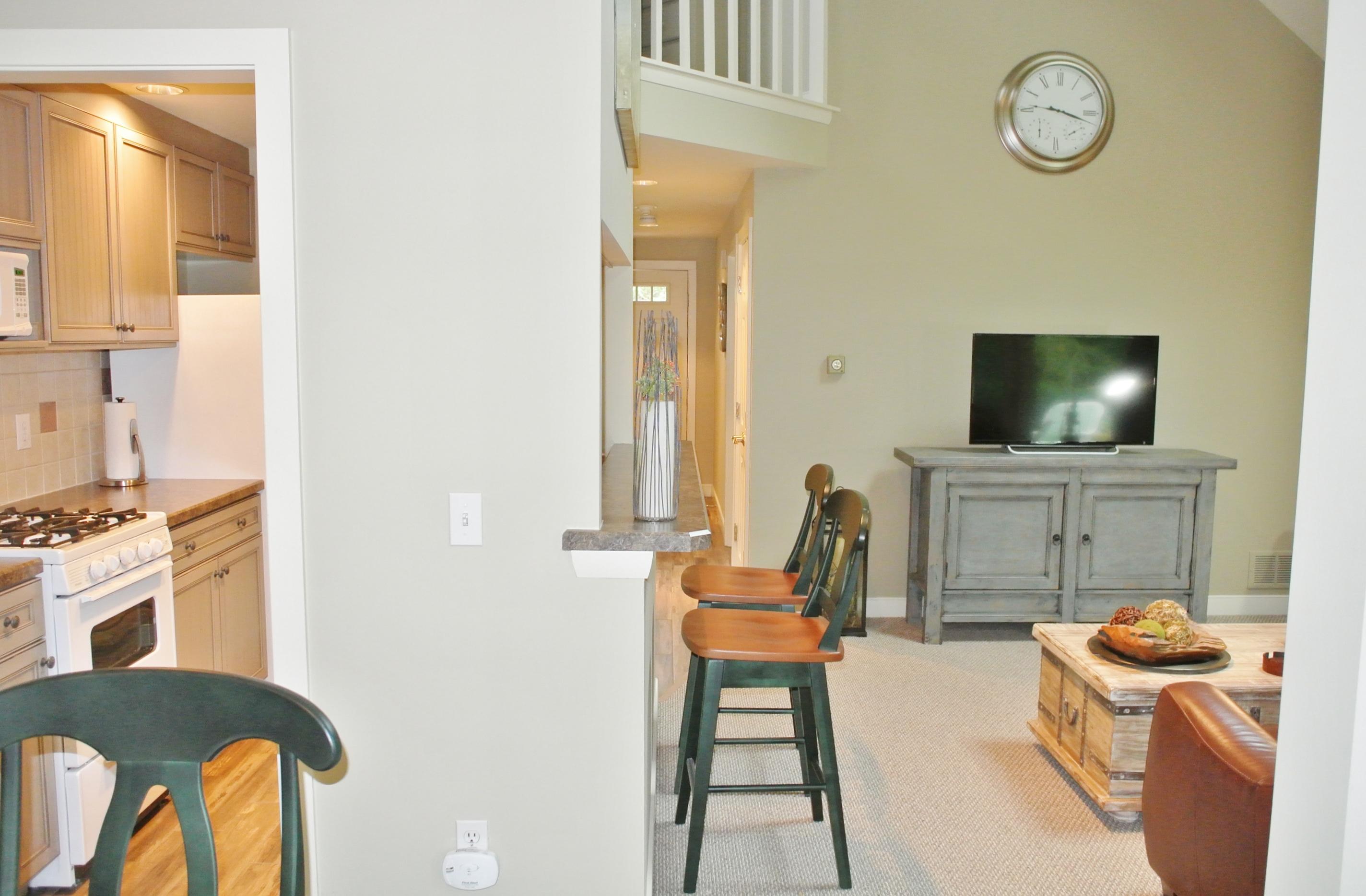 22 Mid-Iron Way, Unit 7509 Mashpee, MA 02649 - Photo 12 of 32 a living room with furniture a flat screen tv and a window