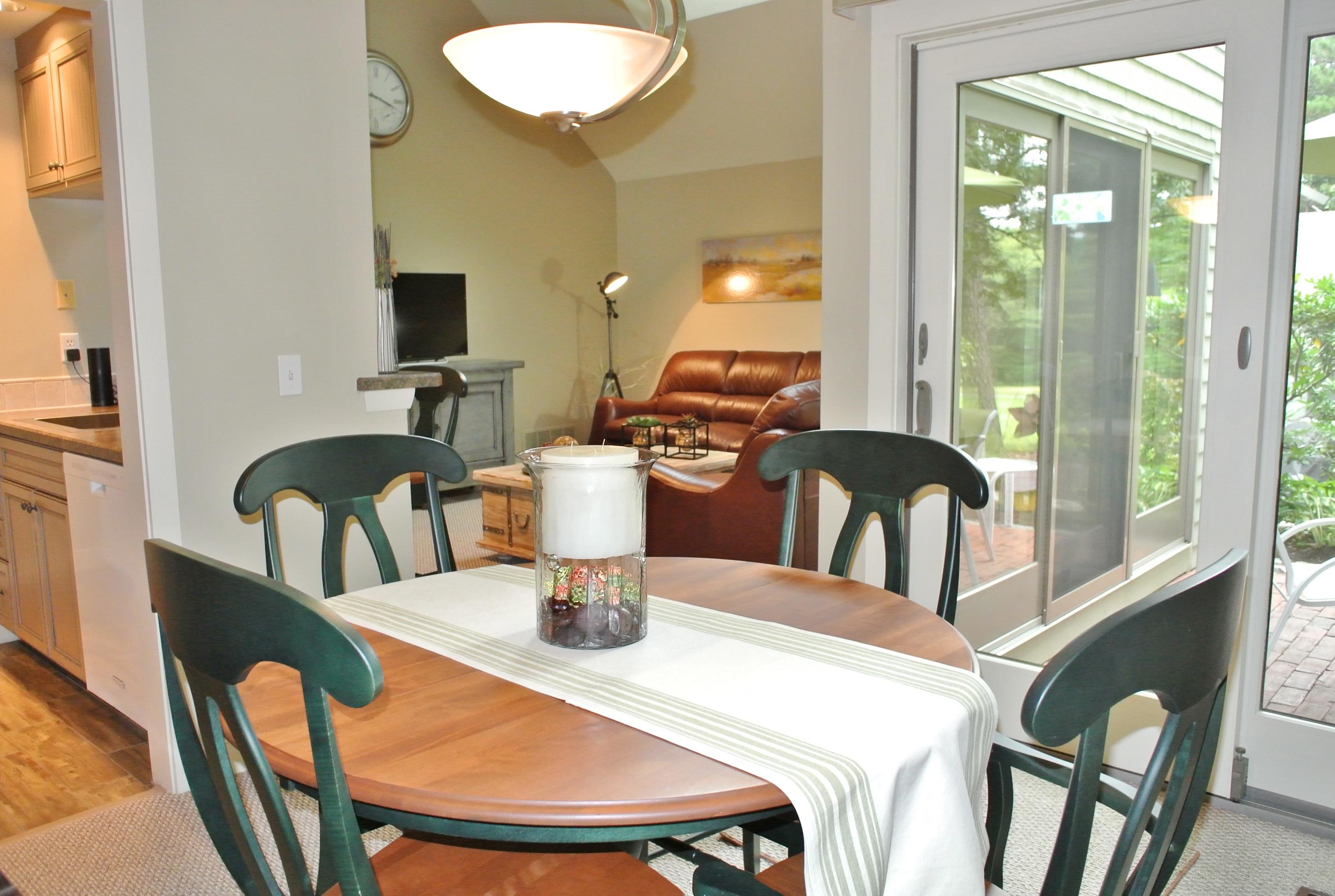22 Mid-Iron Way, Unit 7509 Mashpee, MA 02649 - Photo 13 of 32 a dining room with furniture a lamp and a large window