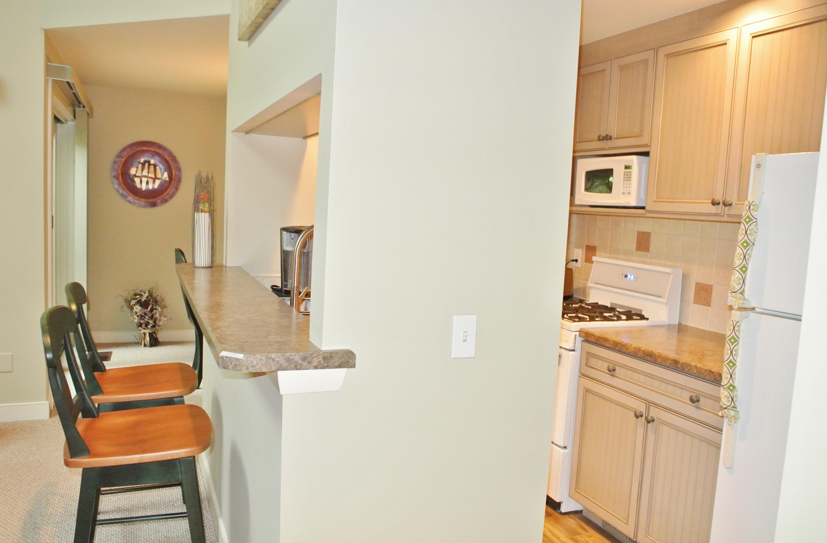 22 Mid-Iron Way, Unit 7509 Mashpee, MA 02649 - Photo 15 of 32 a kitchen with stainless steel appliances granite countertop a refrigerator and a stove top oven