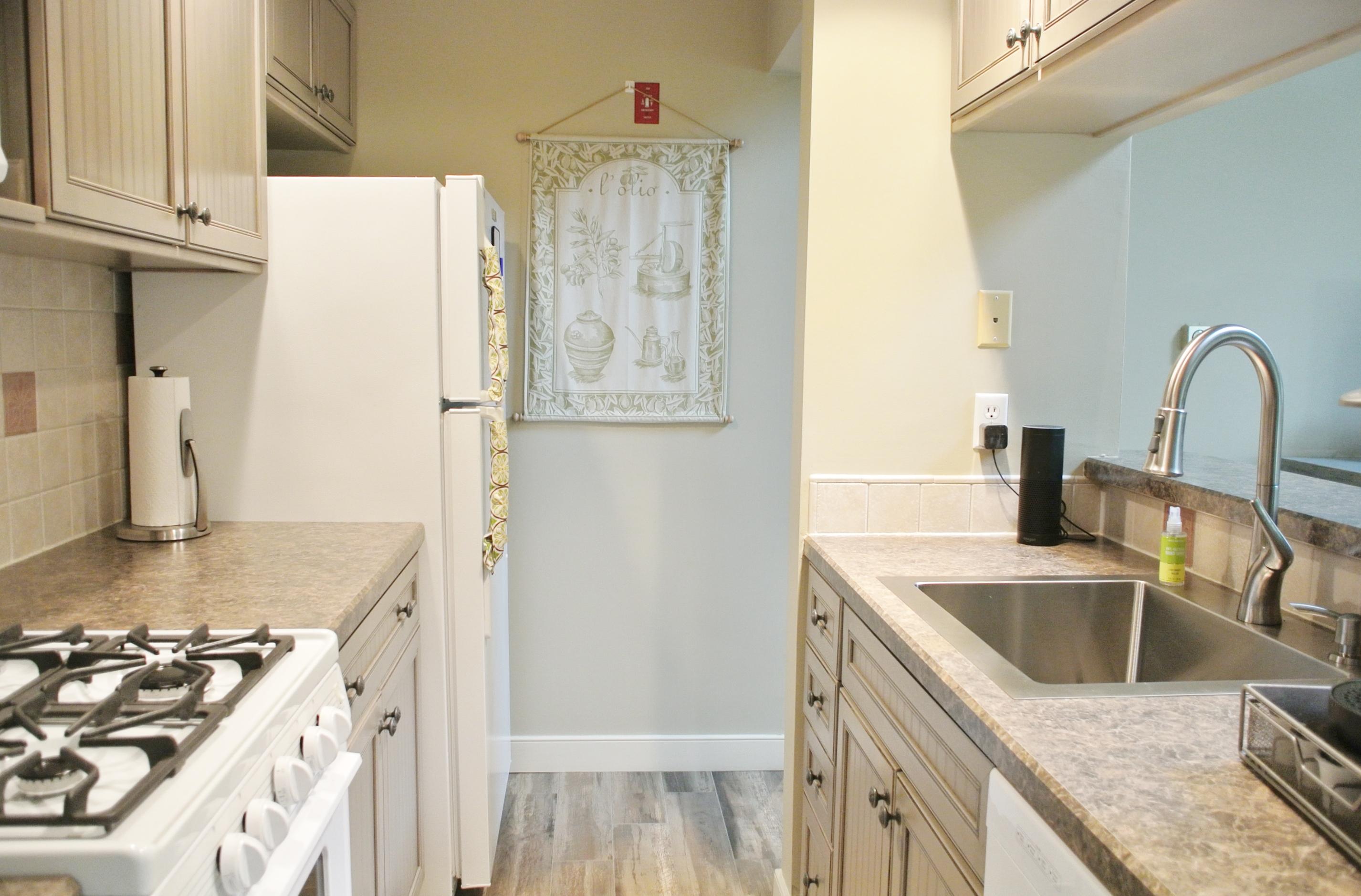 22 Mid-Iron Way, Unit 7509 Mashpee, MA 02649 - Photo 16 of 32 a kitchen with stainless steel appliances granite countertop a sink stove and refrigerator