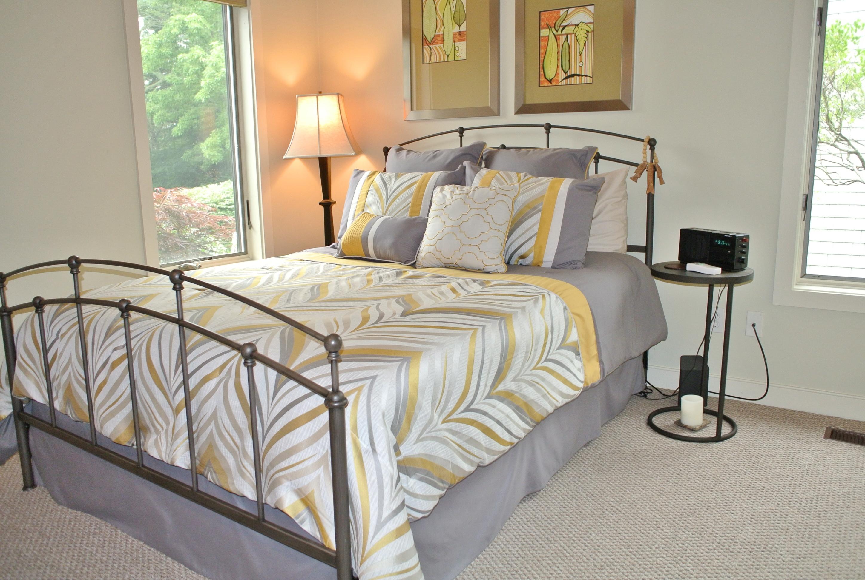 22 Mid-Iron Way, Unit 7509 Mashpee, MA 02649 - Photo 19 of 32 a bedroom with a bed and window