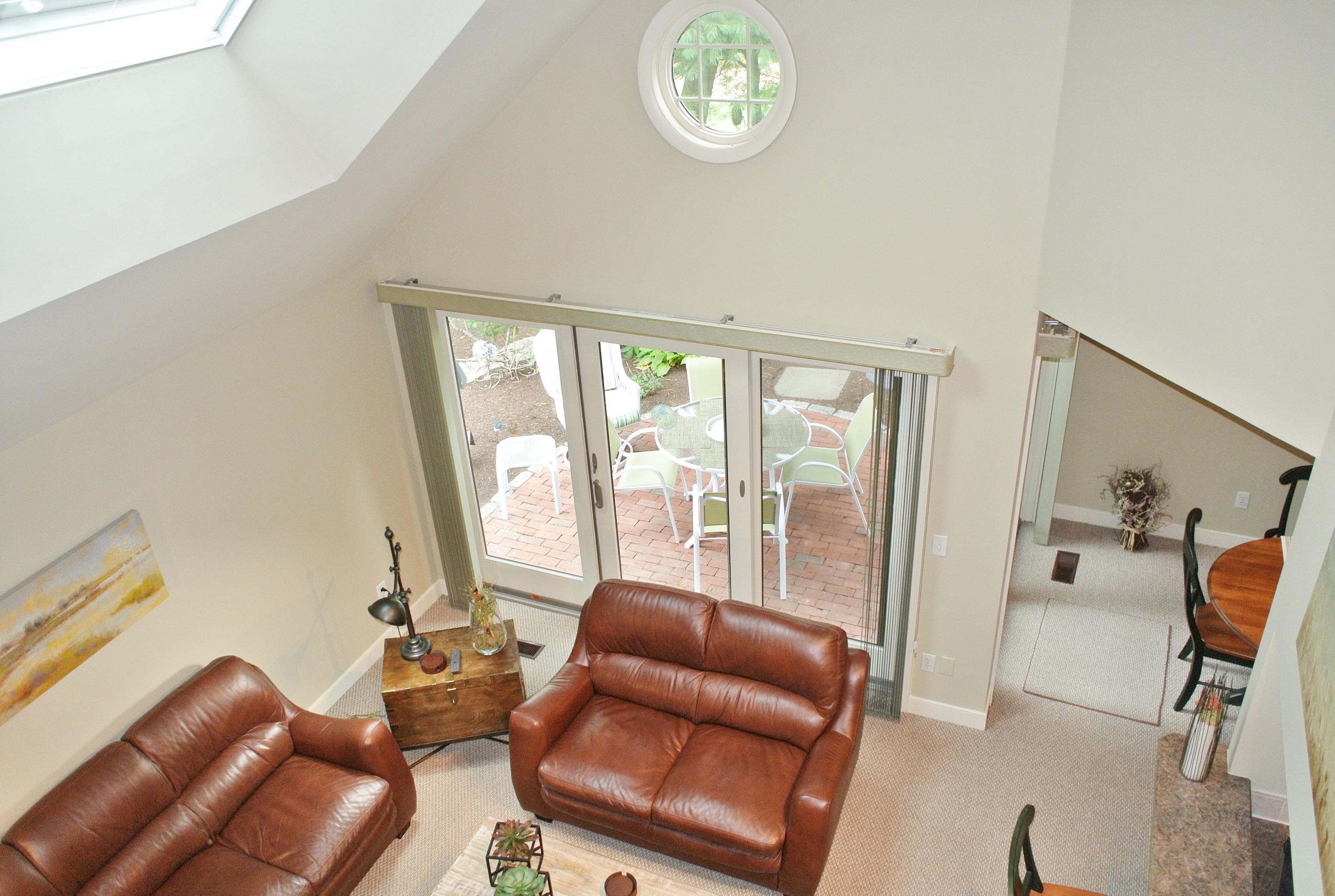 22 Mid-Iron Way, Unit 7509 Mashpee, MA 02649 - Photo 23 of 32 a living room with furniture and a large window