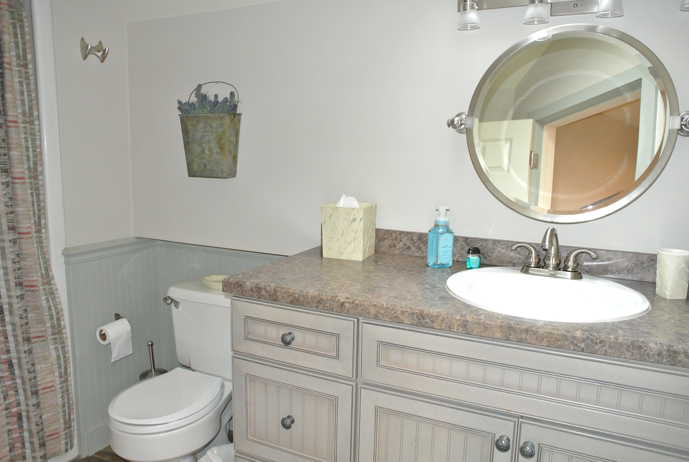 22 Mid-Iron Way, Unit 7509 Mashpee, MA 02649 - Photo 27 of 32 a bathroom with a toilet a sink and mirror
