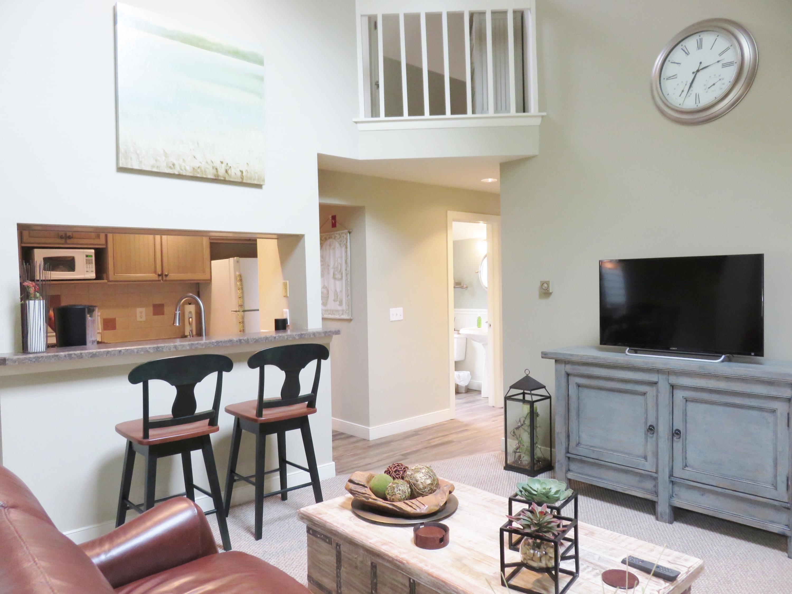22 Mid-Iron Way, Unit 7509 Mashpee, MA 02649 - Photo 7 of 32 a living room with furniture and a flat screen tv