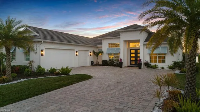 a front view of a house with a yard and outdoor seating
