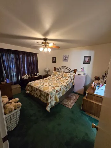 a bedroom with a bed a couch and dresser