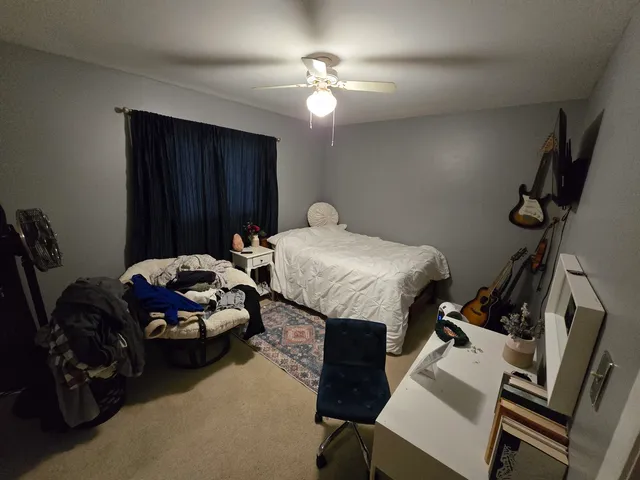 a bedroom with bed and a chandelier
