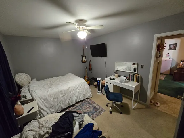 a bedroom with a bed and a chandelier