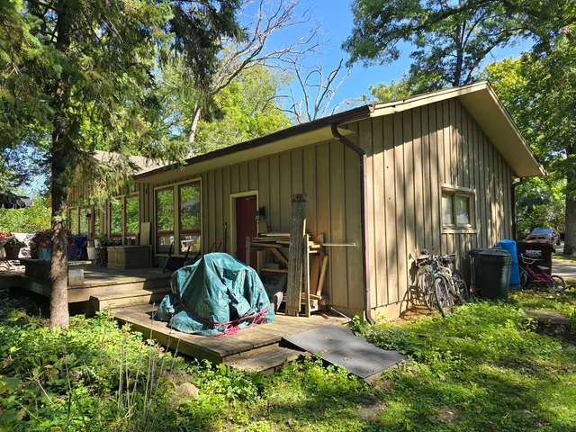 a backyard of a house with table and chairs