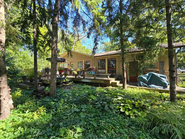a view of a house with backyard sitting area and garden