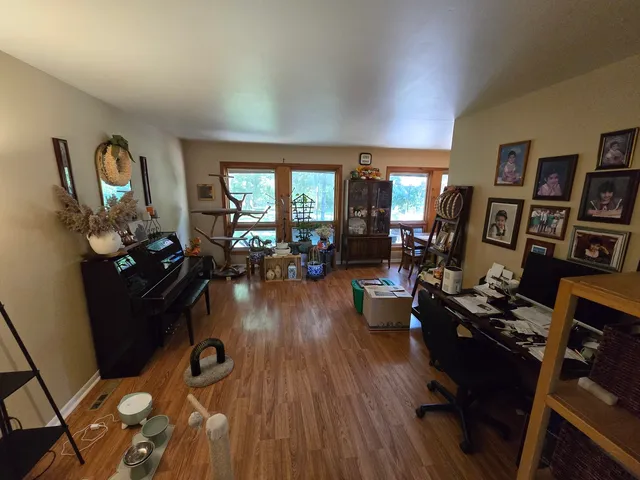 a living room with furniture and wooden floor
