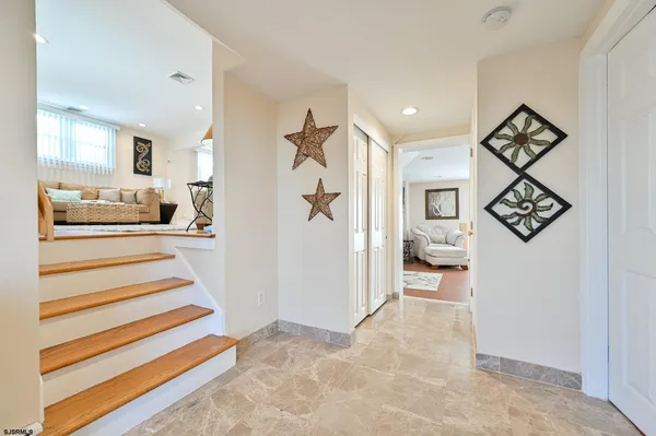 a view of entryway and hall with wooden floor