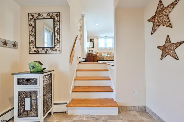 a view of entryway with stairs and wooden floor