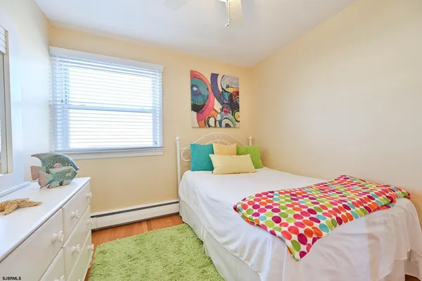 a living room with a bed and next to a window