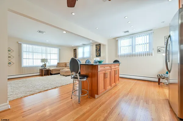 a living room filled with furniture and a wooden floor