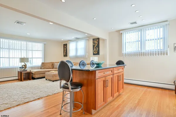 a living room with furniture a window and wooden floor