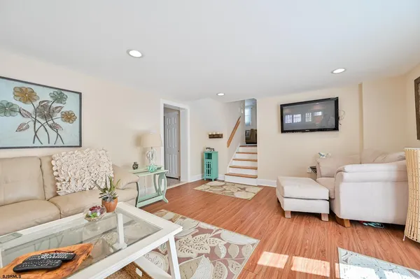 a bedroom with furniture and a wooden floor