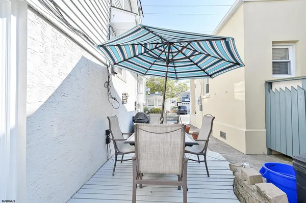 a view of a chairs and table in the balcony