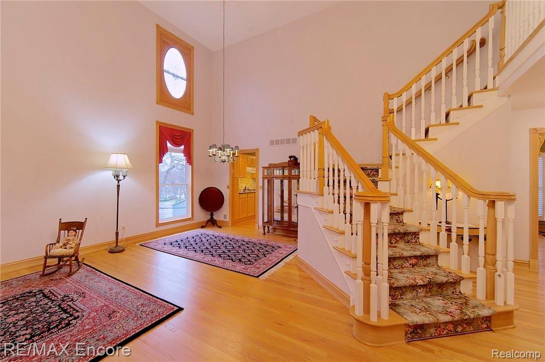 220 Oak Street Rochester, MI 48307 - Photo 6 of 54 Soaring ceiling and windows and winding staircase make a majestic first impression.