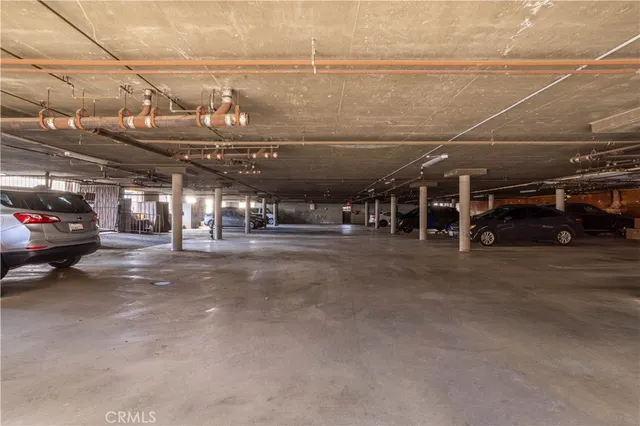 a view of parking garage with cars