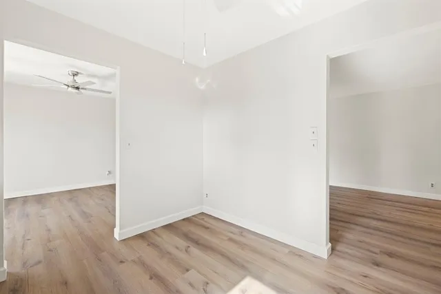 an empty room with wooden floor