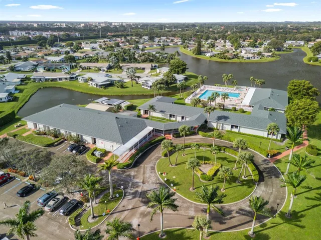 an aerial view of a pool yard and mountain view in back