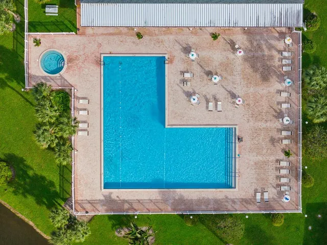 a living room with lots of furniture and a view of kitchen