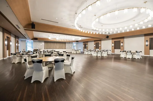 a view of a room that has a window and wooden floor