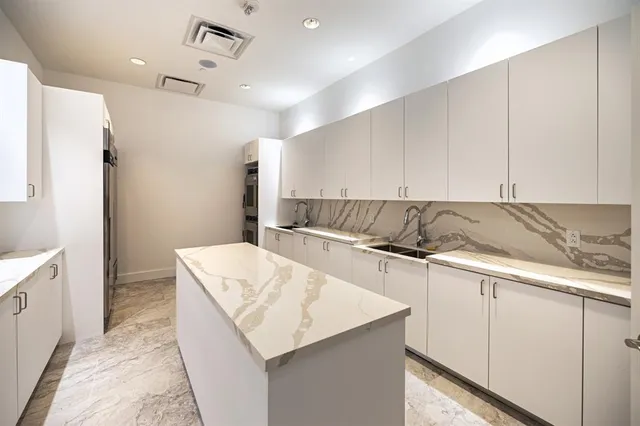a living room with furniture a ceiling fan and a window