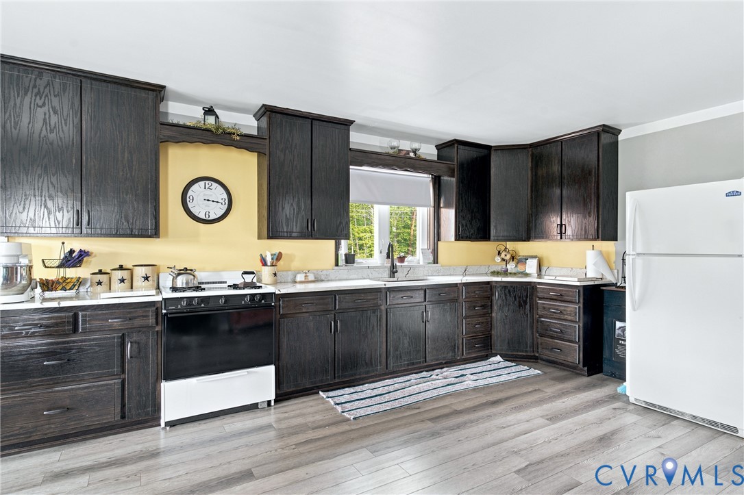 1451 Dixie Hill Road Dillwyn, VA 23936 - Photo 2 of 51 Kitchen featuring dark-stained cabinetry, light-to